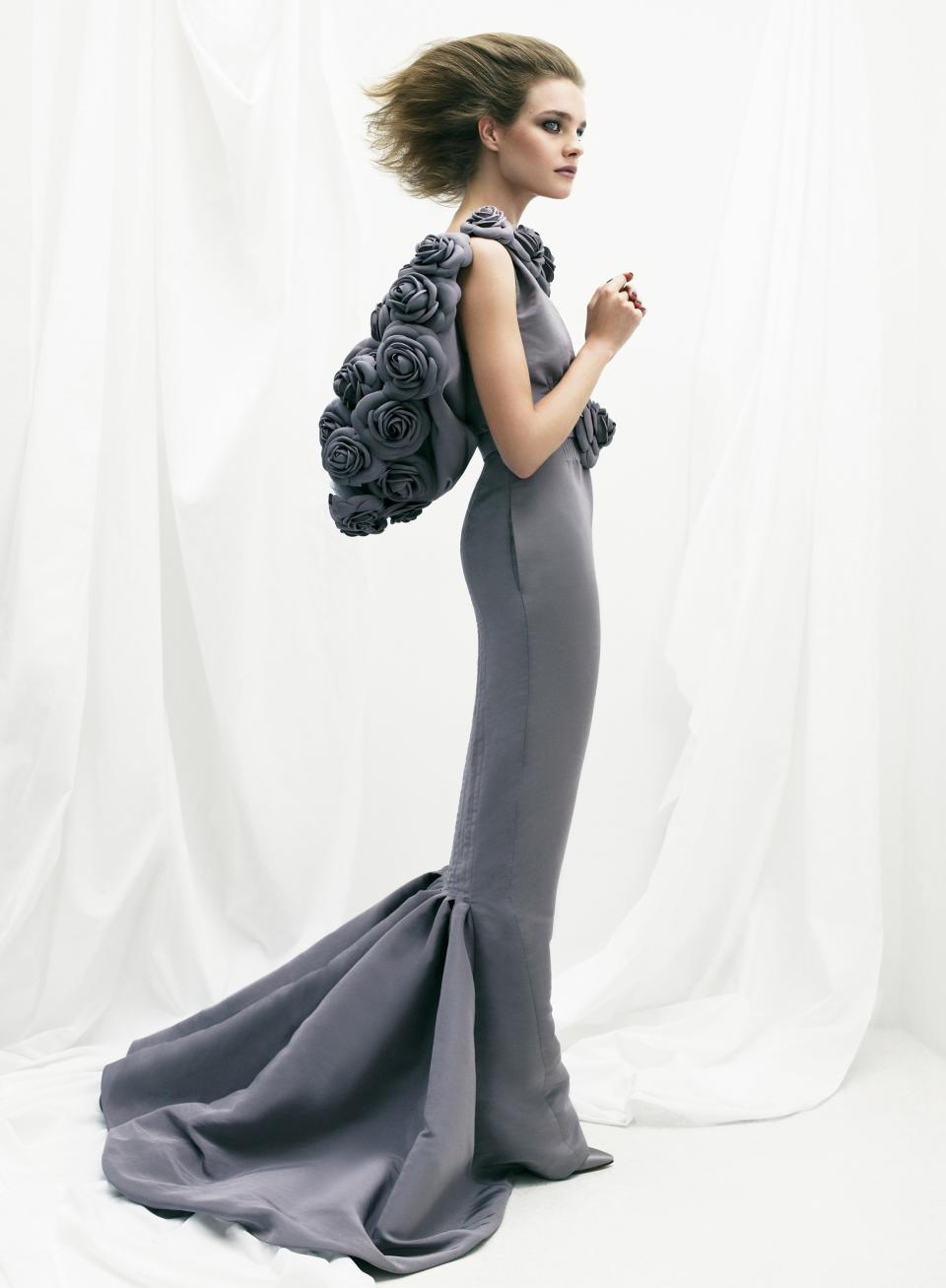 Natalia Vodianova in a slate faille dress with camellias and train by Chanel Haute Couture.