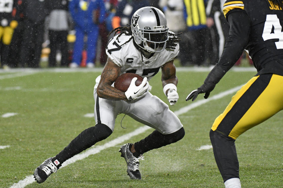 Las Vegas Raiders wide receiver Davante Adams (17) runs after a catch during the first half of an NFL football game against the Pittsburgh Steelers in Pittsburgh, Saturday, Dec. 24, 2022. (AP Photo/Don Wright)