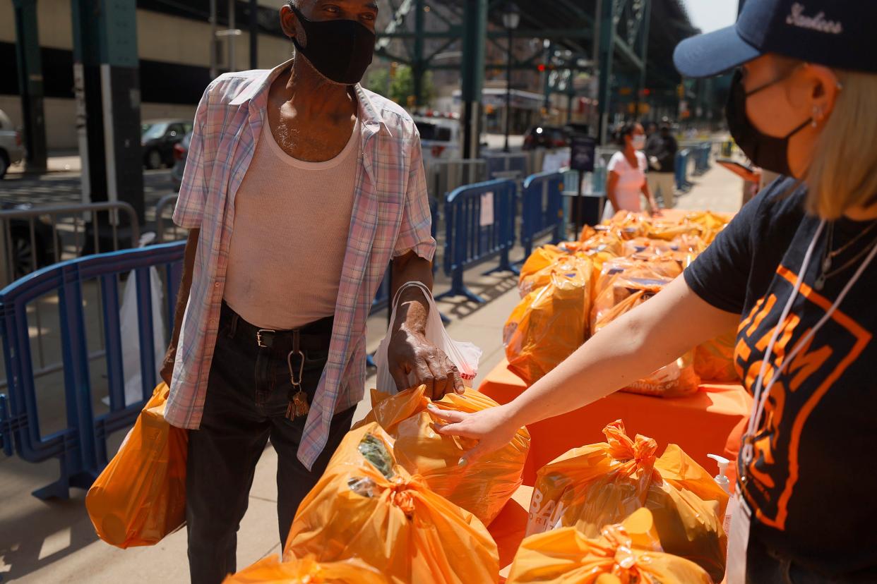  Local residents receive food items as Food Bank For New York City teams up with the New York Yankees to kick-off monthly food distribution for New Yorkers in need at Yankee Stadium on May 20, 2021 in New York City.  (Getty Images for Food Bank For N)