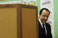 Presidential candidate and former foreign minister Nikos Christodoulides leaves a booth after casting his vote during the presidential elections in Geroskipou in south west coastal city of Paphos, Cyprus, Sunday, Feb. 5, 2023. Cypriots began voting for their eighth new president in the ethnically divided island’s 62-year history as an independent republic, with three front-runners each portraying themselves as the safest bet to guide the country through turbulent economic times and to seek peace with breakaway Turkish Cypriots. (AP Photo/Petros Karadjias)