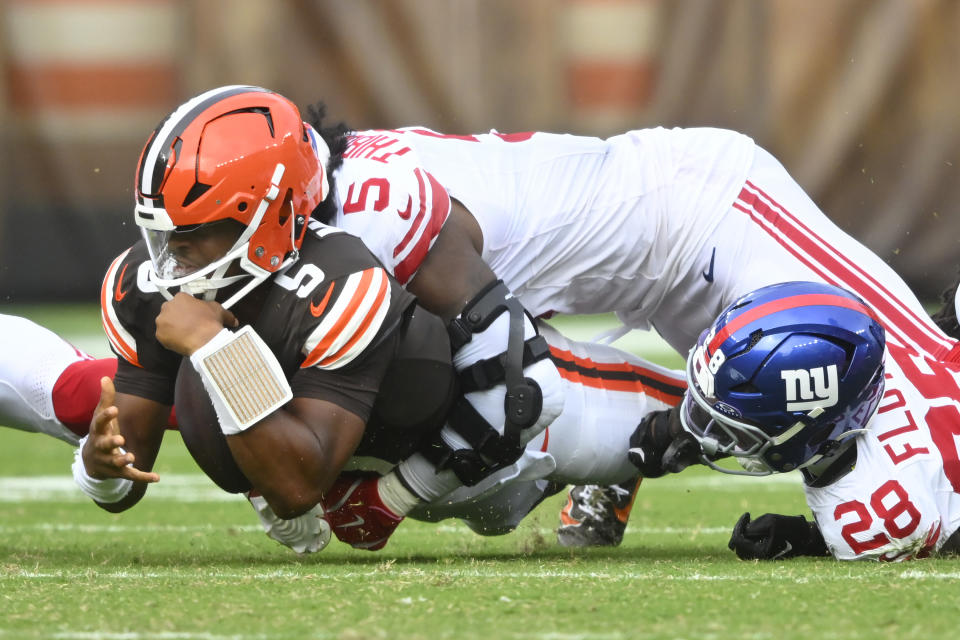 Cleveland Browns quarterback Jameis Winston, foreground left, is tackled by New York Giants linebacker Kayvon Thibodeaux during the second half of an NFL football game, Sunday, Sept. 22, 2024, in Cleveland. (AP Photo/David Richard)