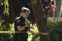Sunnyvale Public Safety Officer Kira Reid secures the perimeter at the apartment complex believed to be associated with a car crash suspect in Sunnyvale, Calif., on Wednesday, April 24, 2019. Investigators are working to determine the cause of a crash in Northern California that injured eight pedestrians on Tuesday evening. Authorities say the driver of a car was taken into custody after he appeared to deliberately plow into them. (AP Photo/Cody Glenn)