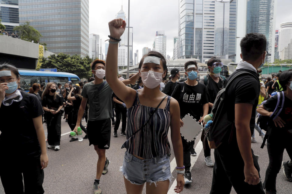Protesters march to surround the police headquarters in Hong Kong on Friday, June 21, 2019. Several hundred mainly student protesters gathered outside Hong Kong government offices Friday morning, with some blocking traffic on a major thoroughfare, after a deadline passed for meeting their demands related to controversial extradition legislation that many see as eroding the territory's judicial independence. (AP Photo/Kin Cheung)