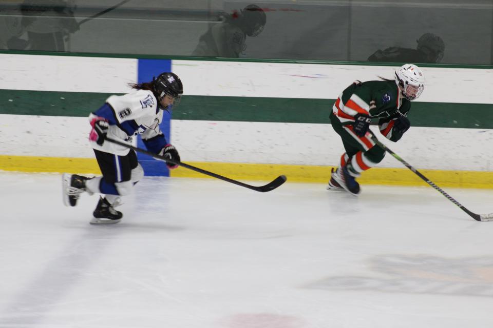Leominster's Kailyn Hawkins chases down Hopkinton's Lucey Jean in a game in Fitchburg on December 11, 2023.