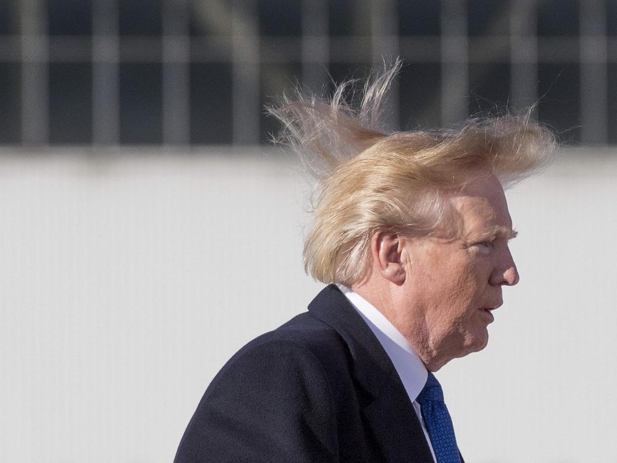 US president Donald Trump's blows in the wind as he boards Air Force One before flying to Vietnam to attend the annual Asia Pacific Economic Cooperation (APEC) summit at Beijing airport on 10 November 2017: (Getty Images)