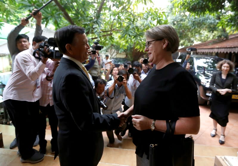 Leader of the Cambodia National Rescue Party (CNRP) Kem Sokha shakes hands with Australian Ambassador to Cambodia Angela Corcoran at his home in Phnom Penh