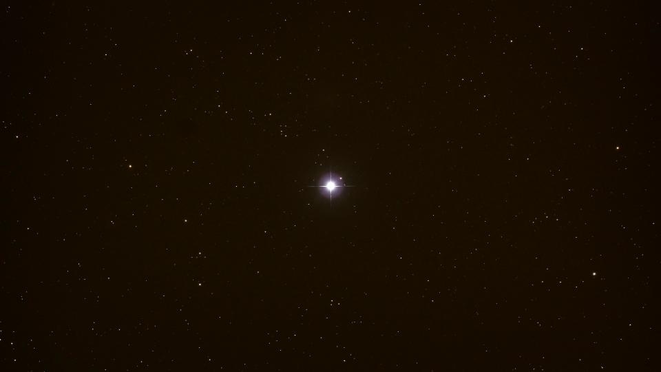 a blue star in the night sky