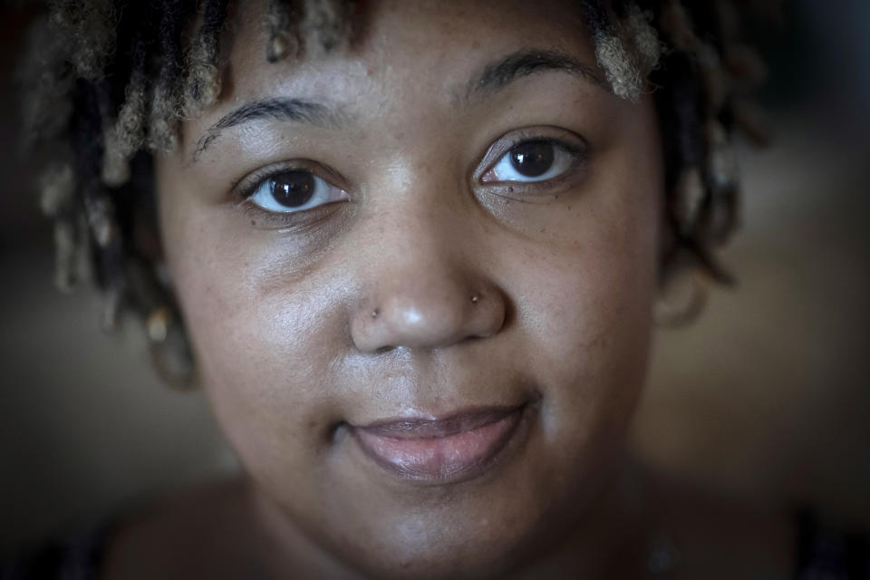 Angelica Lyons poses for a portrait in her parents' home in Birmingham, Ala., on Saturday, Feb. 5, 2022. She believes her near-death experience and subsequent health challenges could have been avoided had doctors not ignored her pleas for help - a reflection, she says, of the medical racism, bias and inattentive care that Black Americans endure. (AP Photo/Wong Maye-E)