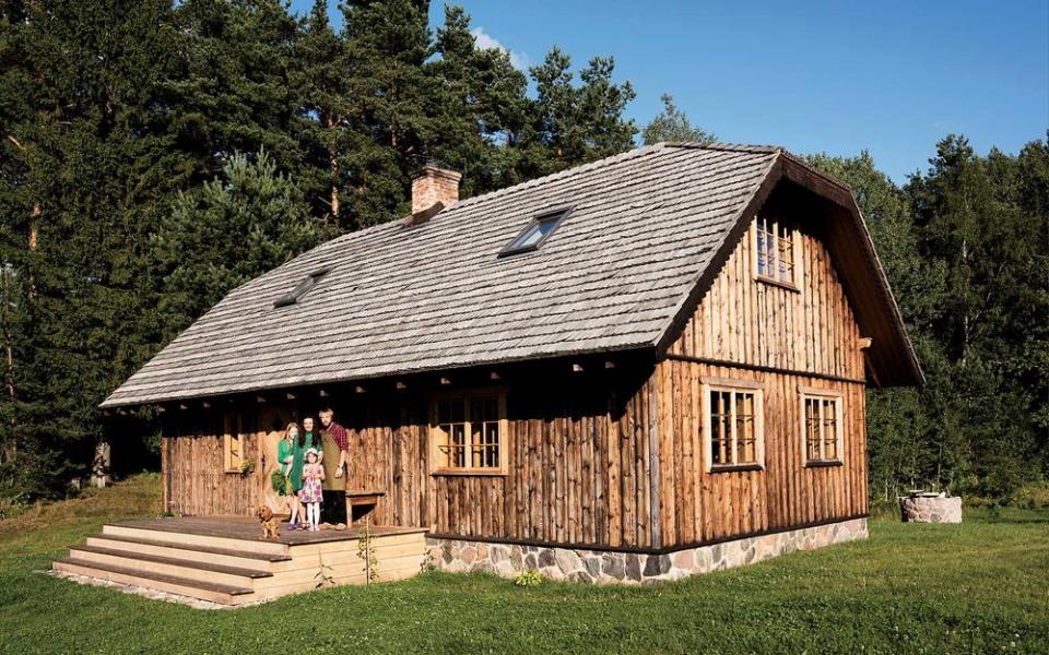 Jacob Dimiters, a carpenter and the founder of the Northmen, an artisans’ guild that produces axes, bows, and watches, with his family at their home in the Latvian countryside between the towns of Sigulda and Cesis.