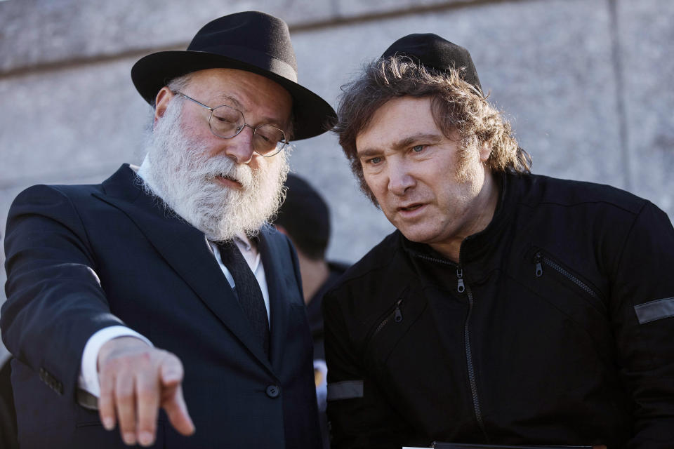 Argentina's President-elect, Javier Milei, second right, visits the Montefiore Cemetery after praying next to Chabad-Lubavitch rabbis at the resting place of the Rebbe, Rabbi Menachem Mendel Schneerson, on Monday, Nov. 27, 2023, in the Queens borough of New York. 7. (AP Photo/Andres Kudacki)