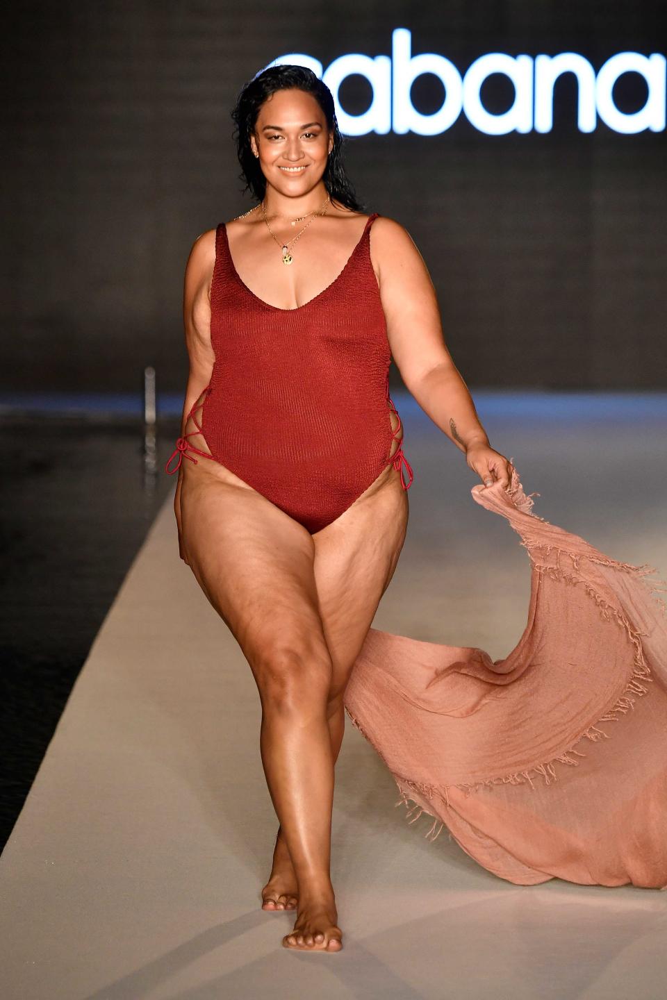 <p>A model walks the runway wearing a red hot one-piece swimsuit for the 2018 <em>Sports Illustrated</em> swimsuit show during Miami Swim Week at the W South Beach hotel on July 15. (Photo: Alexander Tamargo/Getty Images for Sports Illustrated) </p>