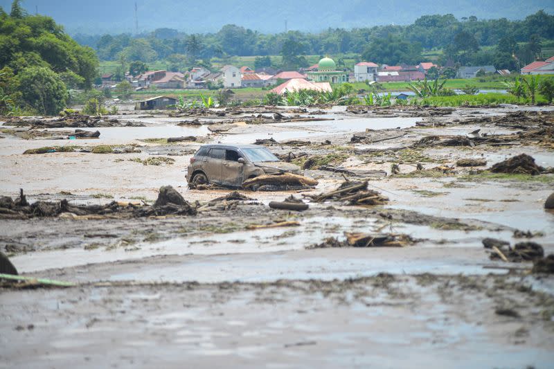 A damaged car is seen in an area affected by heavy rain brought flash floods and landslides in Agam