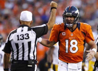 Peyton Manning shows a bit of emotion in his debut with the Broncos. (AP)