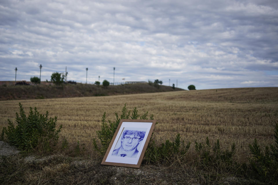 A drawings of former president of Spain's Catalonia region, Carles Puigdemont and member of European Parliament is placed outside Lledoners prison in Sant Joan de Vilatorrada, near Barcelona, Spain, Tuesday, June 22, 2021. Nine Catalan separatist leaders jailed for sedition are eyeing freedom, after Spain's Cabinet pardoned them in the hope of starting what Prime Minister Pedro Sánchez called a much-needed reconciliation in the country's restive northeast. (AP Photo/Joan Mateu)