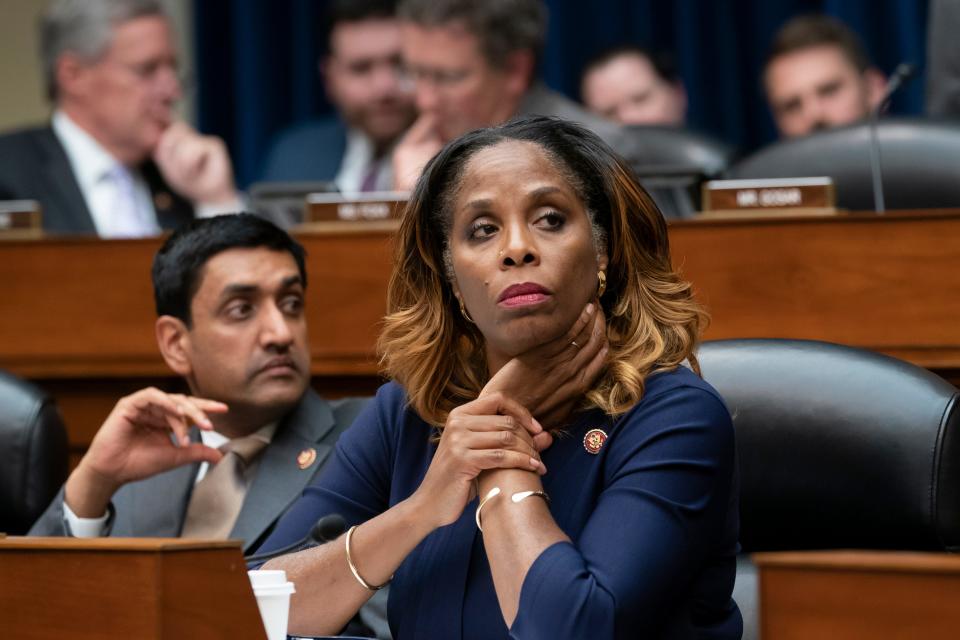 Del. Stacey Plaskett, D-Virgin Islands, joined at left by Rep. Ro Khanna, D-Calif., listen during the roll call as the House Oversight and Reform Committee votes 24-15 to hold Attorney General William Barr and Commerce Secretary Wilbur Ross in contempt for failing to turn over subpoenaed documents related to the Trump administration's decision to add a citizenship question to the 2020 census, on Capitol Hill in Washington, June 12, 2019.