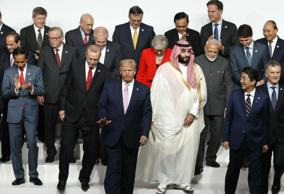 FILE - U.S. President Donald Trump, center, walks off with fellow leaders after a family photo session at G-20 leaders summit in Osaka, Japan, on June 28, 2019. The G-20, whose annual summit plays out in Rome this weekend, has morphed from its creation in the 1990s as an international group to grapple with financial crises into a forum facing such pressing problems as worldwide vaccine access and climate change. (Kim Kyung-Hoon/Pool Photo via AP/file)
