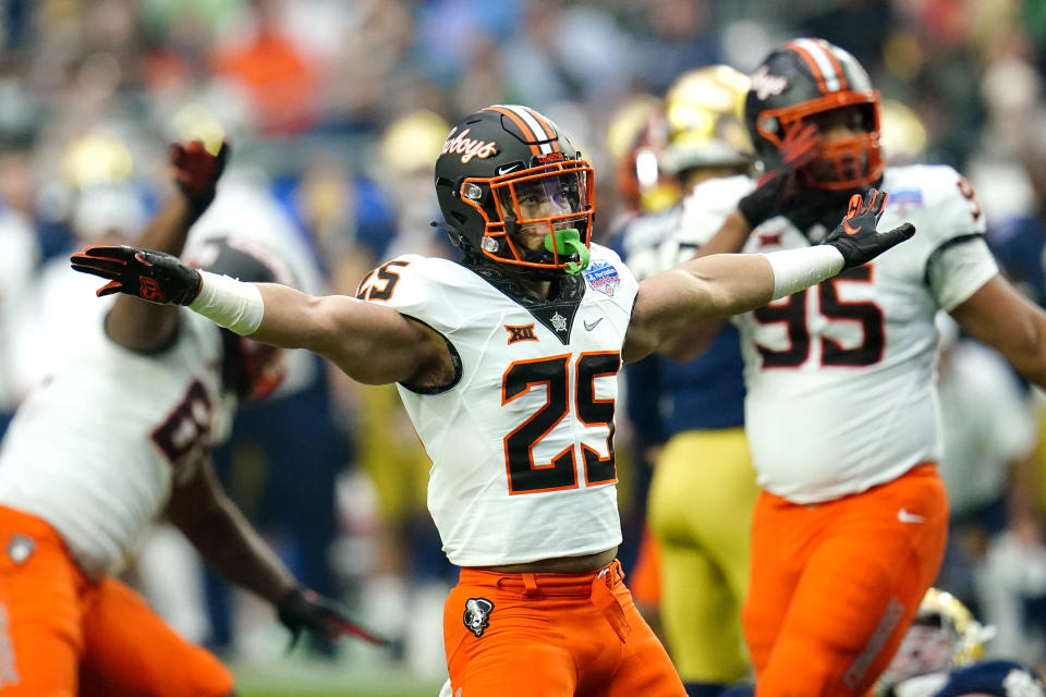 Oklahoma State running back Andre Washington (25) signals after a missed Notre Dame field goal during the first half of the Fiesta Bowl NCAA college football game, Saturday, Jan. 1, 2022, in Glendale, Ariz. (AP Photo/Ross D. Franklin)