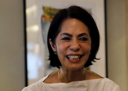 Philippine Environment Secretary Regina Lopez smiles as she greets a friend after attending a meeting in Manila, Philippines February 9, 2017. REUTERS/Erik De Castro