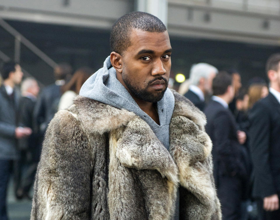 FILE - This Jan. 17, 2014 file photo shows singer Kanye West as he arrives for the Givenchy men's Fall-Winter 2014-2015 fashion collection in Paris. West will not face criminal charges over an incident in which he apparently punched a man in a Beverly Hills chiropractor's office, prosecutors determined Friday, Jan. 31. The Los Angeles County District Attorney's Office rejected a battery case against the rapper because he had reached a civil settlement with the man and there were no significant injuries documented after the altercation. The altercation occurred after the 18-year-old man used a racial slur in an argument with West's fiancee, Kim Kardashian, on Jan. 13, according to a document prepared by a prosecutor. (AP Photo/Zacharie Scheurer, File)