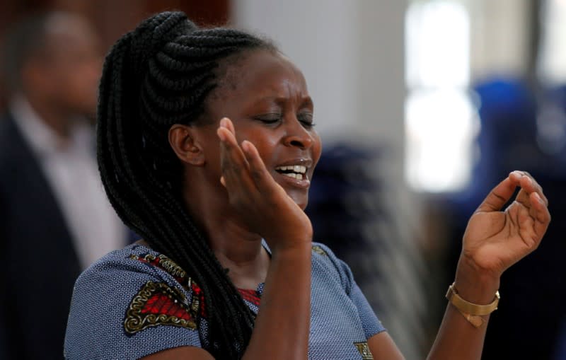 A faithful sings a hymn as she attends a church service amid concerns about the spread of coronavirus disease (COVID-19) at the African Inland Church (AIC) Milimani in Nairobi