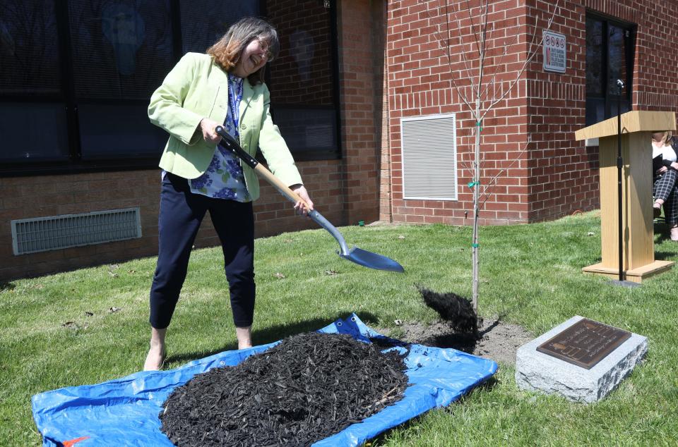 At the Valley Road School, Susan Davis shovels some dirt onto a tree that was just planted and dedicated to her, during an Arbor Day Celebration, honoring Davis who is retiring in June after 50 years of teaching in the Stanhope school district  on April 29, 2022.