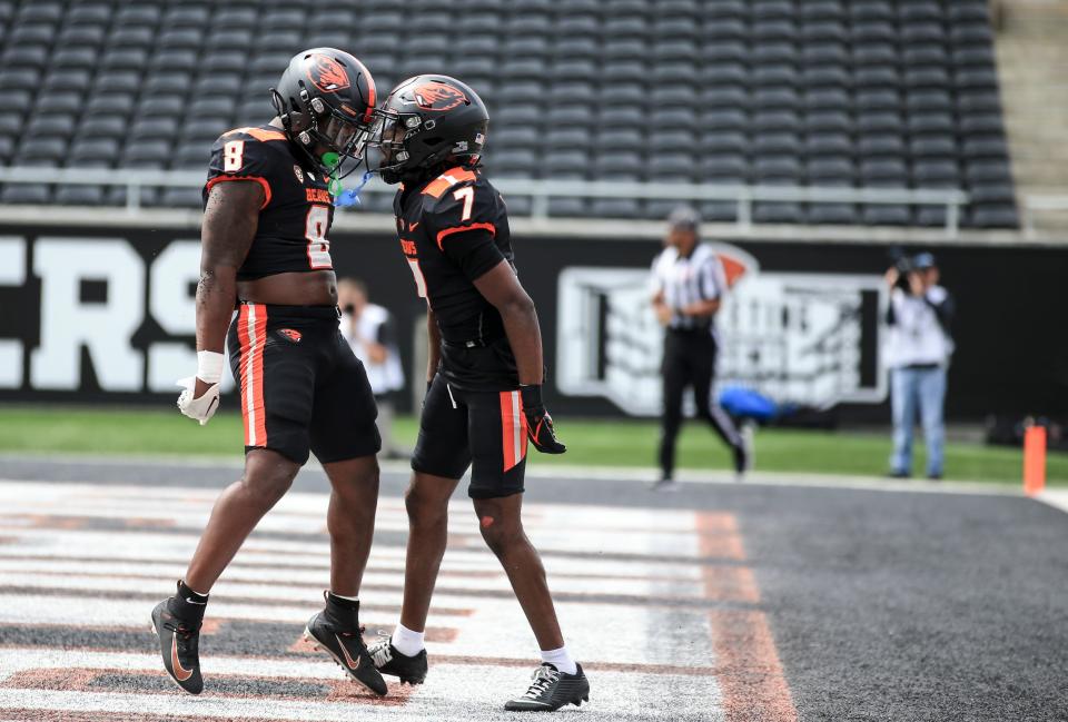 Oregon State’s Jam Griffin and Silas Bolden celebrate an offensive touchdown during the spring showcase at Reser Stadium, Saturday, April 22, 2023, in Corvallis, Ore.