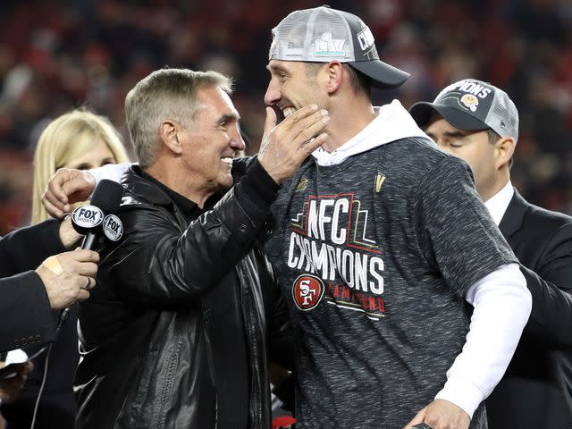 <p>Kiyoshi Mio/Icon Sportswire/Getty</p> Kyle Shanahan hugs his father Mike Shanahan after winning an NFC Conference Championship game on January 19, 2020, at Levi's Stadium in Santa Clara, California.