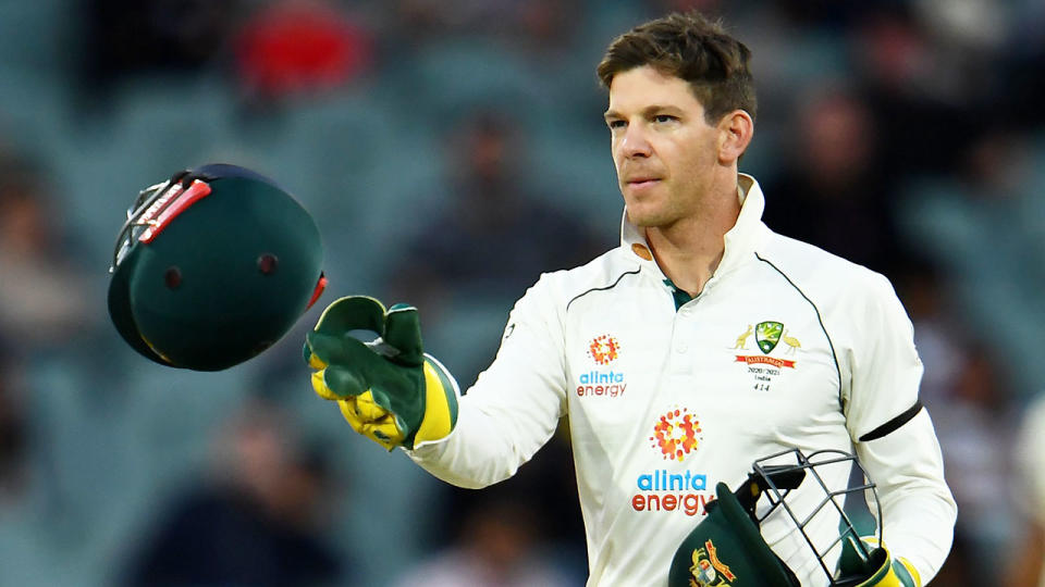 Tim Paine is seen here tossing a helmet to a teammate during the first Test against India.