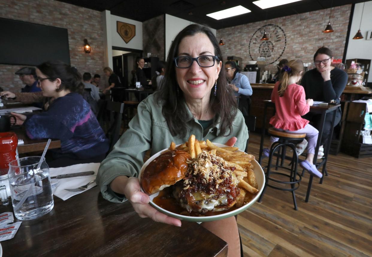 Jeanne Muchnick with a Rail Trail Burger at the Rail Trail Cafe in Blauvelt April 5, 2024.