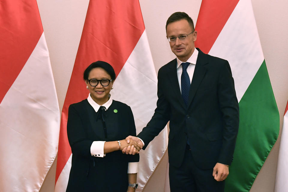 Hungarian Minister of Foreign Affairs and Trade Peter Szijjarto, right, receives Indonesian Foreign Minister Retno Marsudi in the Ministry of Foreign Affairs and Trade in Budapest, Hungary, Tuesday, September 17, 2019. (Zoltan Mathe/MTI via AP)