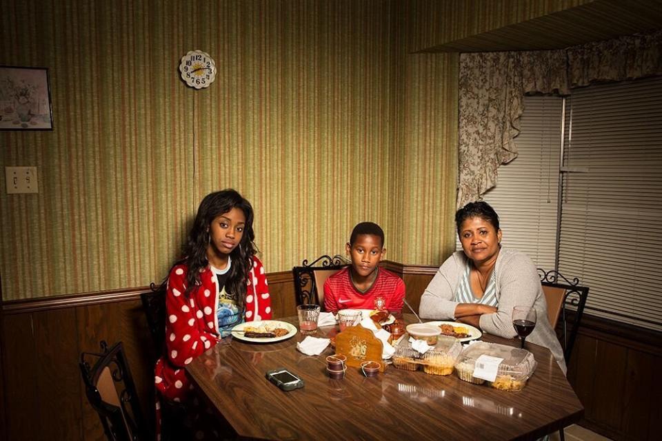 Seynabou, Rui James and Marie&nbsp;eat dinner in Louisiana. (Photo: LOIS BIELEFELD)