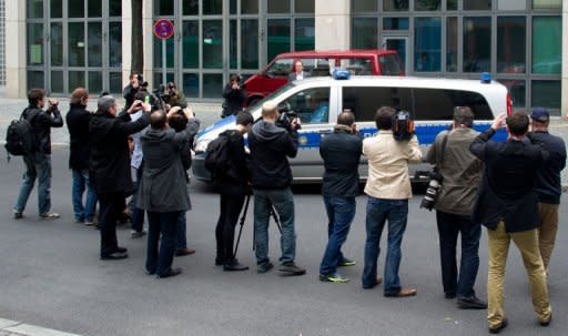 Journalists take pictures of a Police car transporting Canadian porn actor Luka Rocco Magnotta as he leaves the main detention center in Berlin on June 5. New videos circulating on the Internet of the Canadian porn actor appear to be credible, but a probe is ongoing, Montreal police said Wednesday