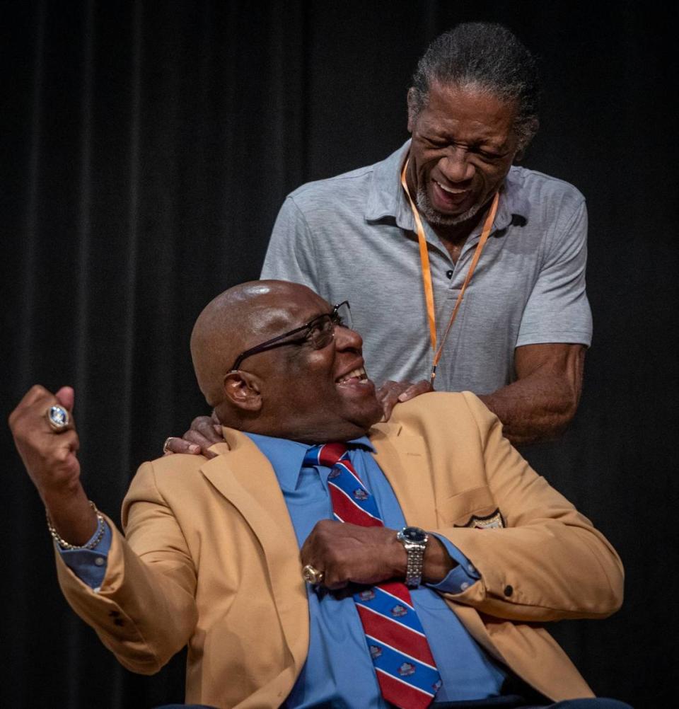 Larry Little and Mercury Morris share a light moment during a street-naming ceremony held at the Booker T. Washington High School auditorium on March 27.