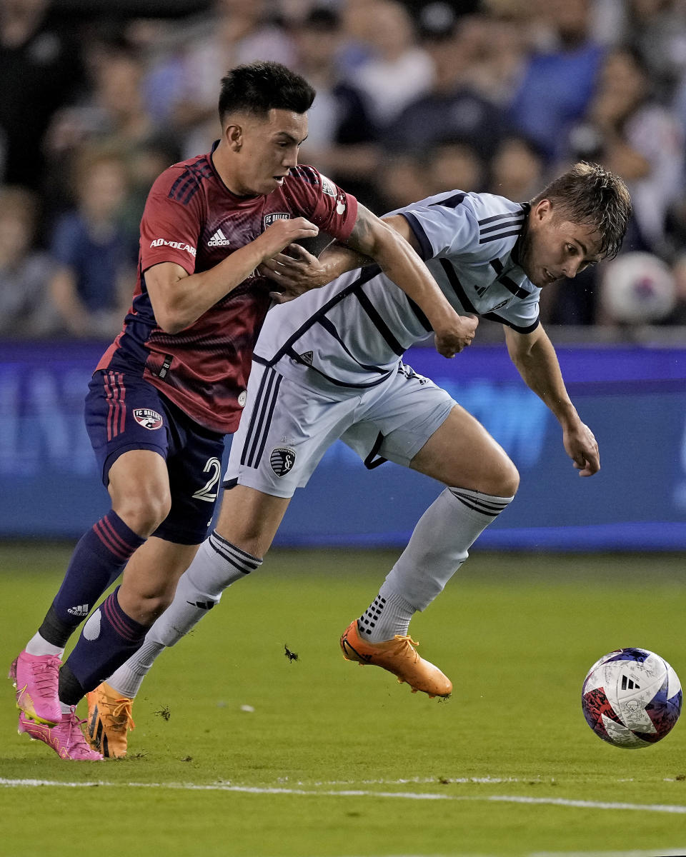 FC Dallas forward Alan Velasco, left, and Sporting Kansas City midfielder Jake Davis chase after the ball during the first half of an MLS soccer match Wednesday, May 31, 2023, in Kansas City, Kan. (AP Photo/Charlie Riedel)