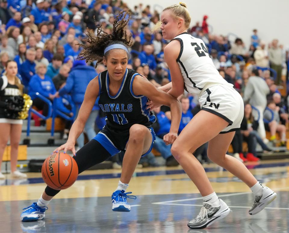 Hamilton Southeastern Royals guard Kennedy Holman (11) pushes her way up the court against Noblesville Millers guard Kate Rollins (24) on Saturday, Feb. 3, 2024, during the IHSAA girls basketball sectional Class 4A game at Hamilton Southeastern High School in Indianapolis. The Noblesville Millers defeated the Hamilton Southeastern Royals, 49-45.