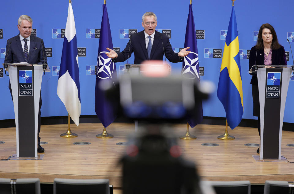 FILE - NATO Secretary General Jens Stoltenberg, center, participates in a media conference with Finland's Foreign Minister Pekka Haavisto, left, and Sweden's Foreign Minister Ann Linde, right, at NATO headquarters in Brussels, Jan. 24, 2022. Security concerns over Russia’s ongoing invasion of Ukraine changed the calculus for Finland and Sweden which have long espoused neutrality and caused other traditionally “neutral” countries to re-think what that term really means for them. (AP Photo/Olivier Matthys, File)