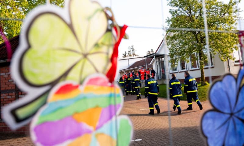 Shamrocks made by children from a kindergarten hang at the assembly point of the emergency services searching for a missing six year old boy. Daniel Bockwoldt/dpa