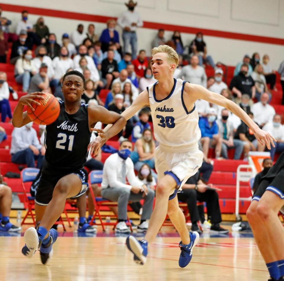 North Forney guard Pardon Mangwiro (21) races ahead of Joshua forward Levi Marriot (30) for the shot during the second half of a 5A region 2 bi-district basketball game at Grapevine High School in Grapevine, Texas, Tuesday, Feb. 23, 2021. North Forney defeated Joshua 61-50. (Special to the Star-Telegram Bob Booth)