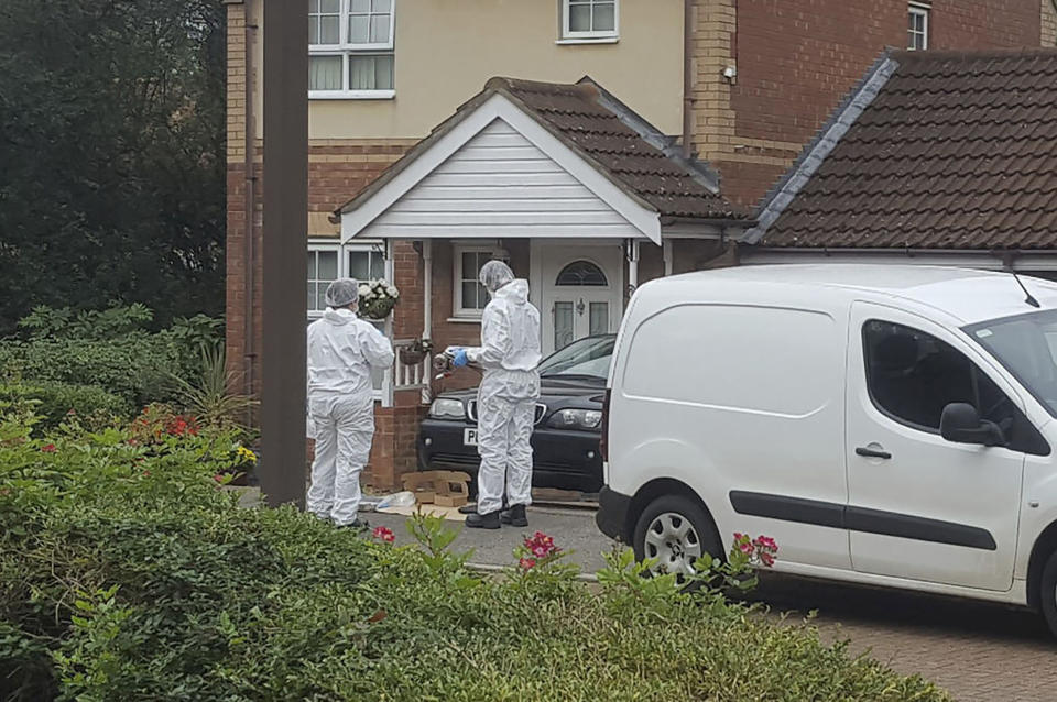 Police attend the scene where two teenage boys were stabbed to death Saturday night following an altercation, in Milton Keynes, southern England, Sunday Oct. 20, 2019.  One of the the 17-year-old victims, who have not been named by police, died at the scene, while the other died later in hospital Sunday morning. (Gus Carter/PA via AP)