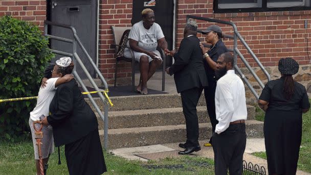 PHOTO: Parishioners from Kingdom Life Church pray with residents after a mass shooting during a block party at the Brooklyn Homes neighborhood in Baltimore. Md., July 2, 2023. (Carol Guzy/Zuma Press)