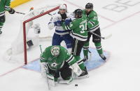 Tampa Bay Lightning's Alexander Volkov (92) battles with Dallas Stars' Denis Gurianov (34) and Joel Hanley (39) as Stars goalie Anton Khudobin (35) makes the save during the third period of an NHL Stanley Cup finals hockey game in Edmonton, Alberta, on Monday, Sept. 28, 2020. (Jason Franson/The Canadian Press via AP)