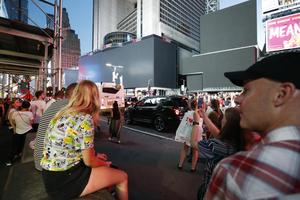 Screens in Times Square are black during a widespread power outage, Saturday, July 13, 2019, in New York. Authorities say a transformer fire caused a power outage in Manhattan and left businesses without electricity, elevators stuck and subway cars stalled. (AP Photo/Michael Owens)