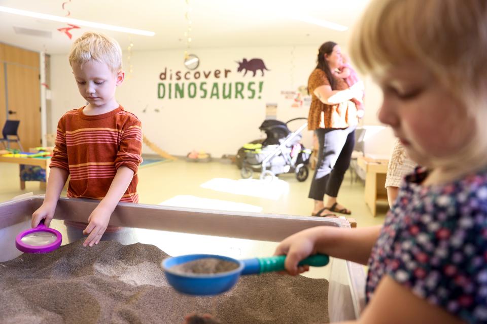 Children dig for fossils in the library's Discovery Room in October 2023.