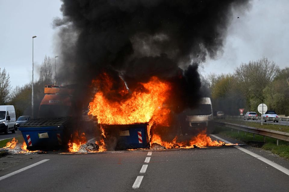 Dumpsters engulfed in flames block part of a highway during a protest in Rennes, northwest France on March 20, 2023.