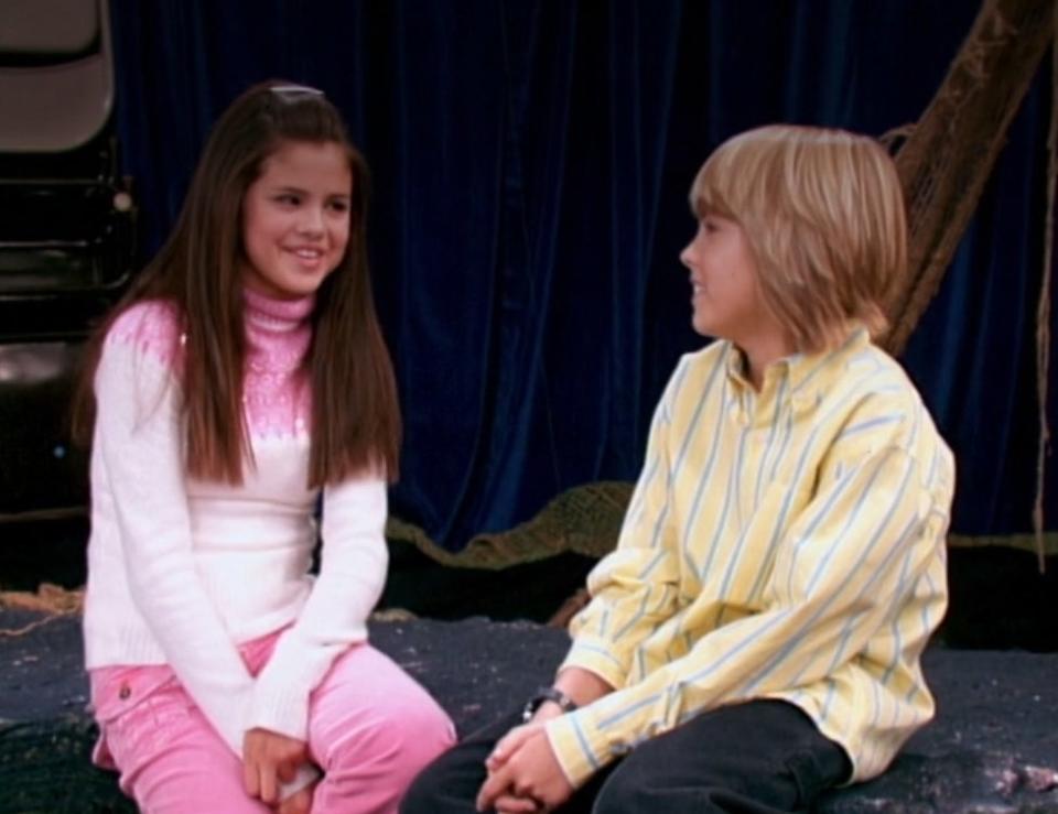 Selena Gomez talks to Cole Sprouse onstage