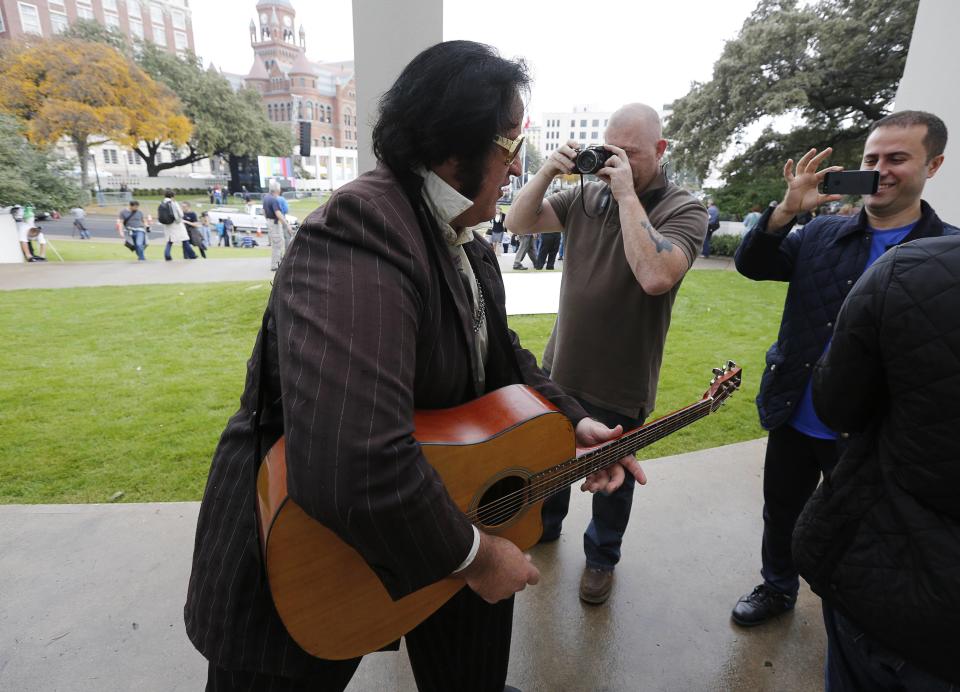 Elvis Presley impersonator sings songs at the top of the "Grassy Knoll" in Dealey Plaza, in Dallas