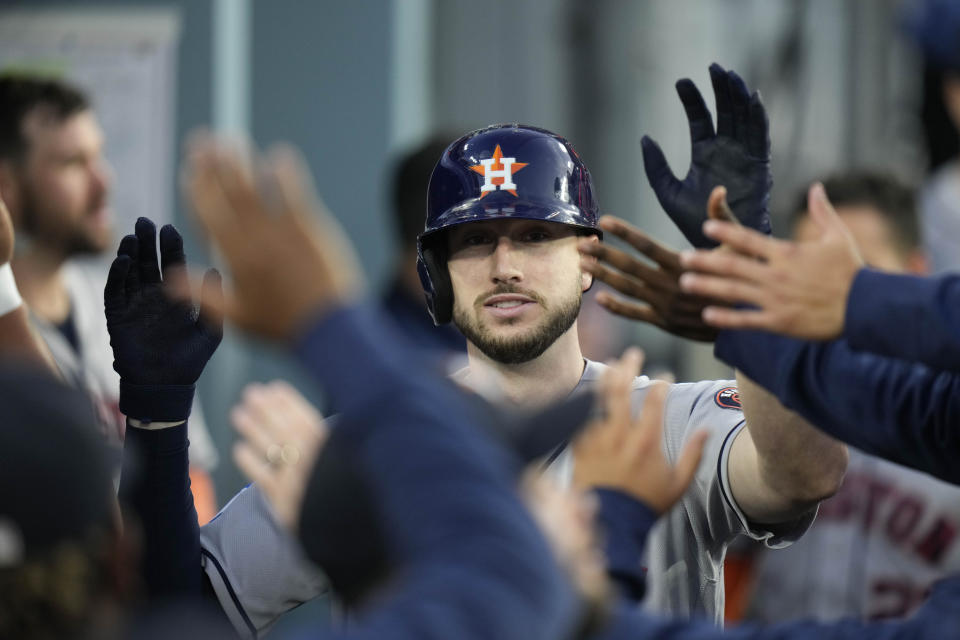 Houston Astros' Kyle Tucker, center, is congratulated for his home run against the Los Angeles Dodgers during the fourth inning of a baseball game Friday, June 23, 2023, in Los Angeles. (AP Photo/Jae C. Hong)