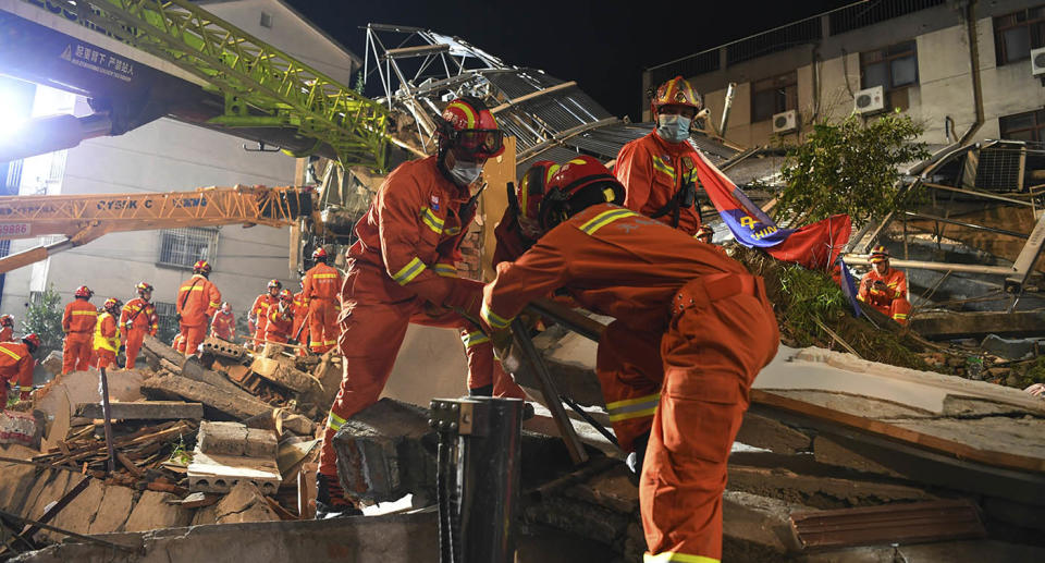 Rescuers prepare equipment as they search for survivors at a collapsed hotel in Suzhou in eastern China's Jiangsu Province. Source: AP