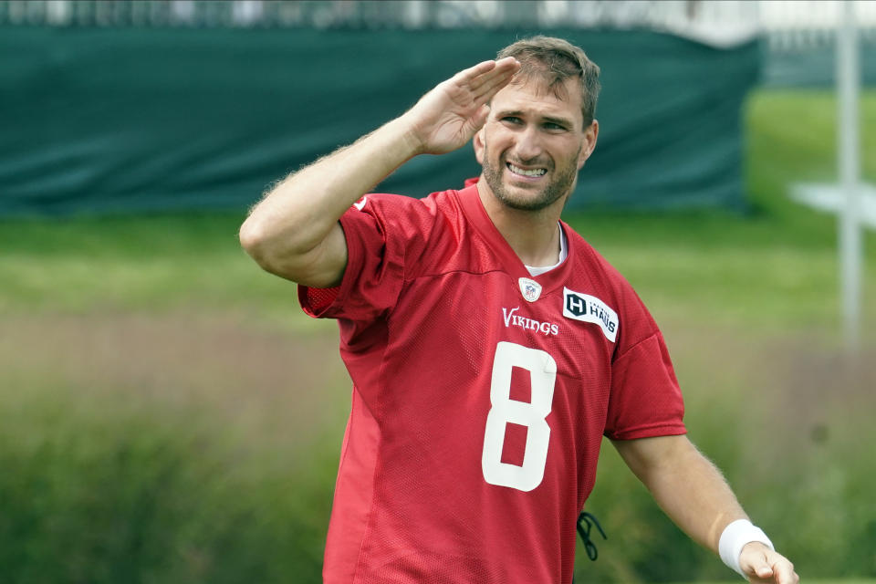 Minnesota Vikings quarterback Kirk Cousins (8) salutes fans as he returned to NFL footballtraining camp after a five-day quarantine because of the coronavirus pandemic, Thursday, Aug. 5, 2021, in Eagan, Minn. (AP Photo/Jim Mone)