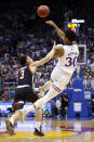 Kansas guard Ochai Agbaji (30) passes off the ball as Texas Tech guard Clarence Nadolny (3) pressures during the first half of an NCAA college basketball game on Monday, Jan. 24, 2022 in Lawrence, Kan. (AP Photo/Colin E. Braley)